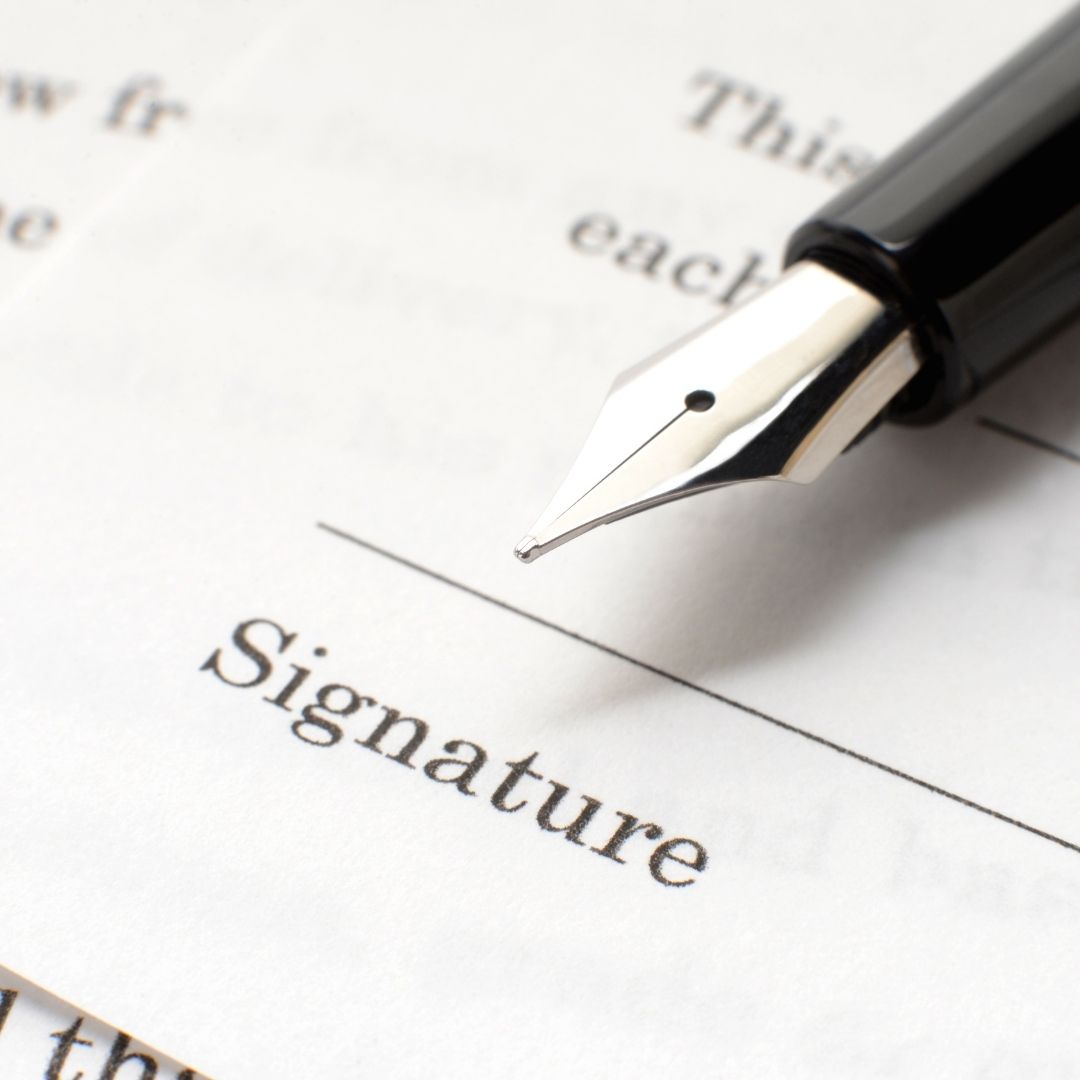 Signing a Deed Poll document for a legal name change in the UK.