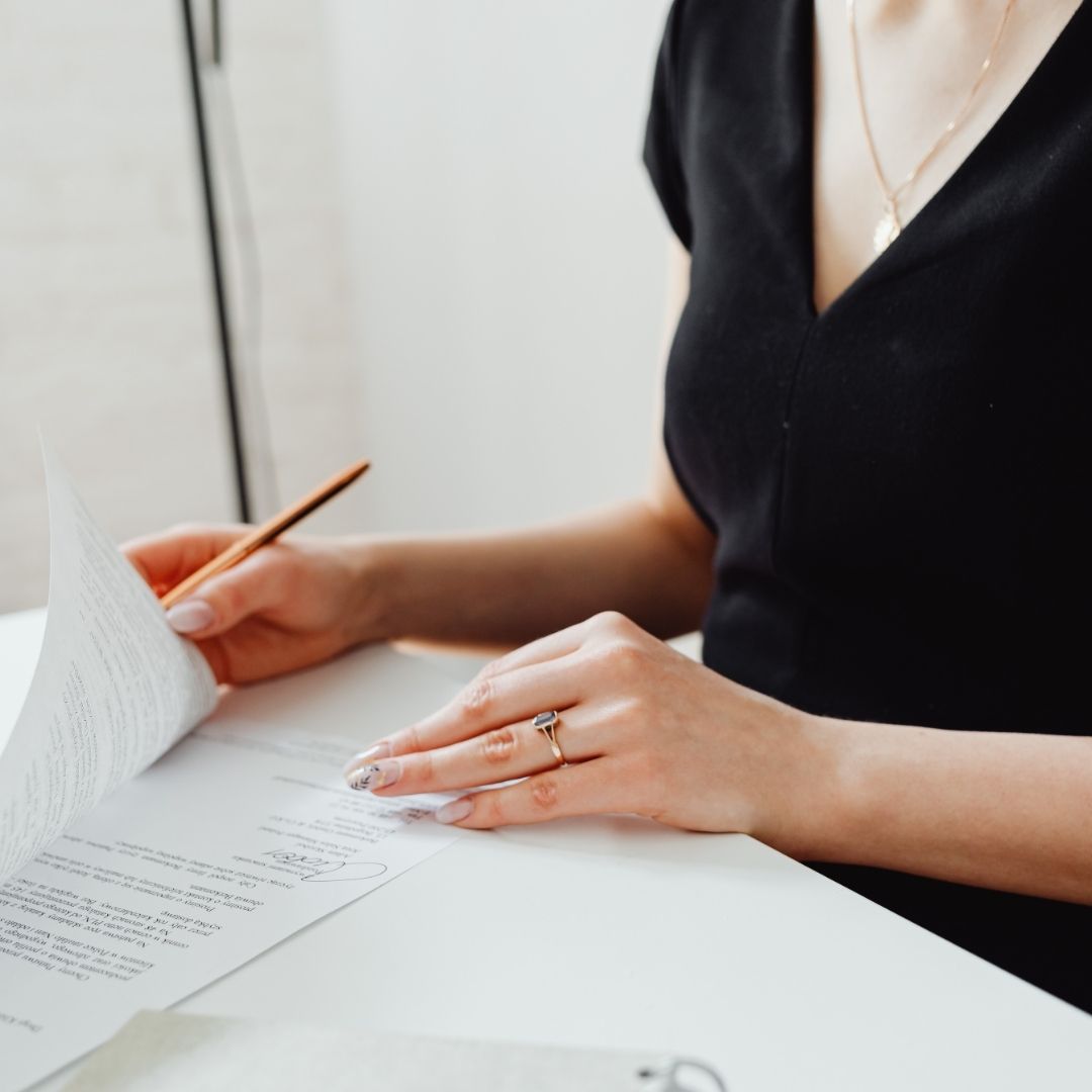 Person completing a UK deed poll name change alongside passport and identity documents.